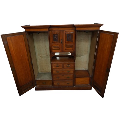 1038 - Edwardian satinwood compactum wardrobe with two bevelled glass mirrored doors, two central cupboard ... 