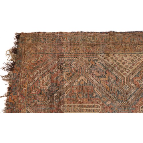 1022 - Antique Turkish rug having an all over blue and red geometric design, 180cm x 146cm