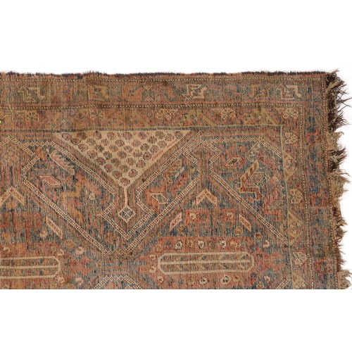 1022 - Antique Turkish rug having an all over blue and red geometric design, 180cm x 146cm