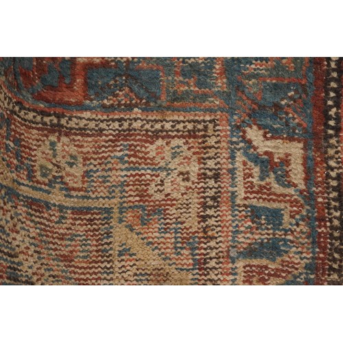 1022 - Antique Turkish rug having an all over blue and red geometric design, 180cm x 146cm