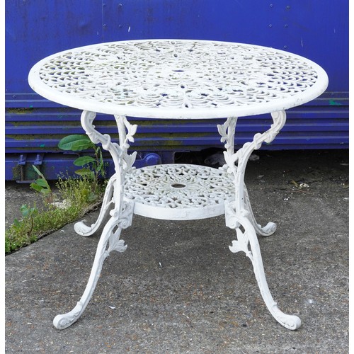 1142 - White painted aluminium garden table and four chairs, the table 67cm high x 87cm in diameter