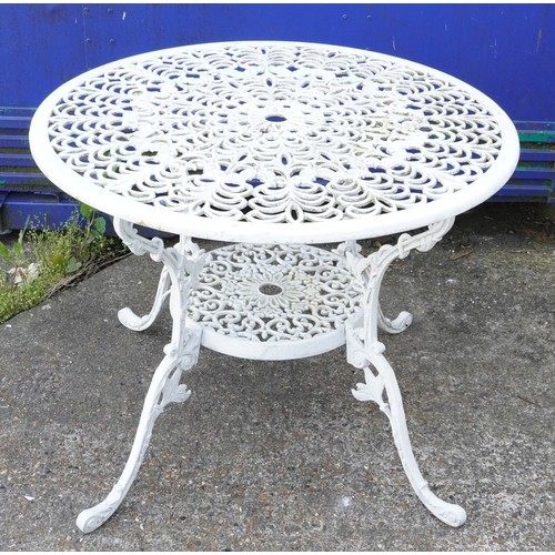 1142 - White painted aluminium garden table and four chairs, the table 67cm high x 87cm in diameter