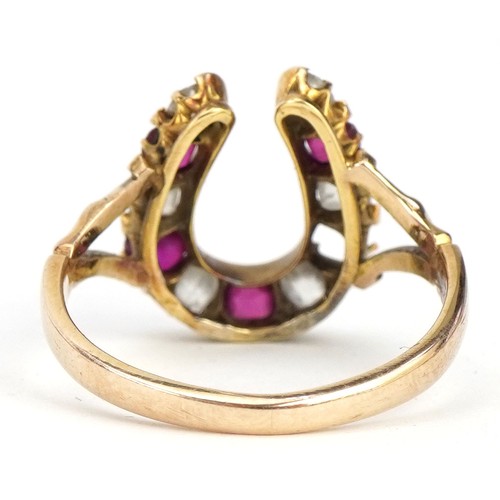 2307 - 19th century unmarked gold diamond and ruby horseshoe ring, tests as 18ct gold, the largest diamond ... 