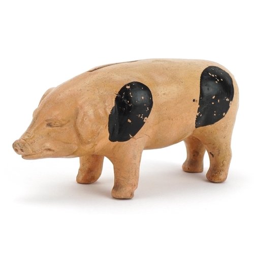 140 - Hand painted pottery moneybox in the form of a pig, 15cm in length