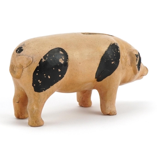 140 - Hand painted pottery moneybox in the form of a pig, 15cm in length