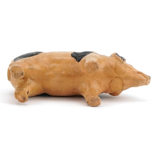 140 - Hand painted pottery moneybox in the form of a pig, 15cm in length