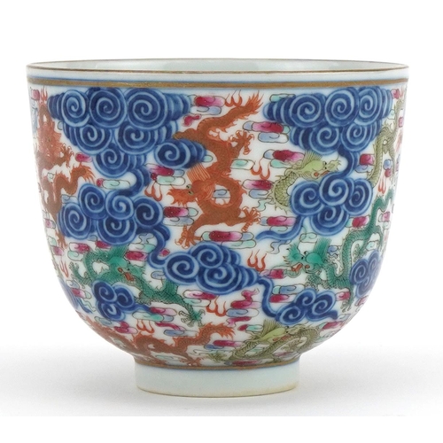 102 - Chinese doucai porcelain tea bowl hand painted with dragons amongst clouds, six figure character mar... 