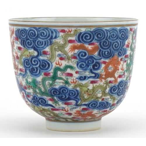 102 - Chinese doucai porcelain tea bowl hand painted with dragons amongst clouds, six figure character mar... 