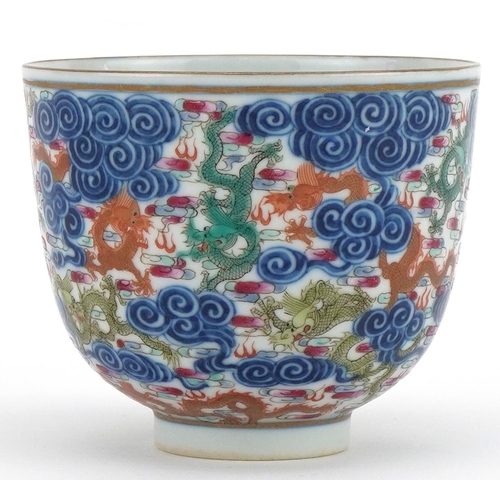 102 - Chinese doucai porcelain tea bowl hand painted with dragons amongst clouds, six figure character mar... 