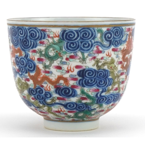 102 - Chinese doucai porcelain tea bowl hand painted with dragons amongst clouds, six figure character mar... 