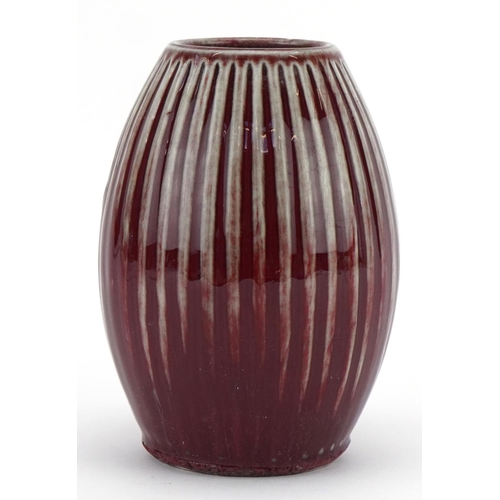 449 - Chinese porcelain fluted vase having a sang de boeuf glaze, 15cm high