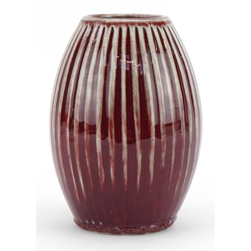 449 - Chinese porcelain fluted vase having a sang de boeuf glaze, 15cm high