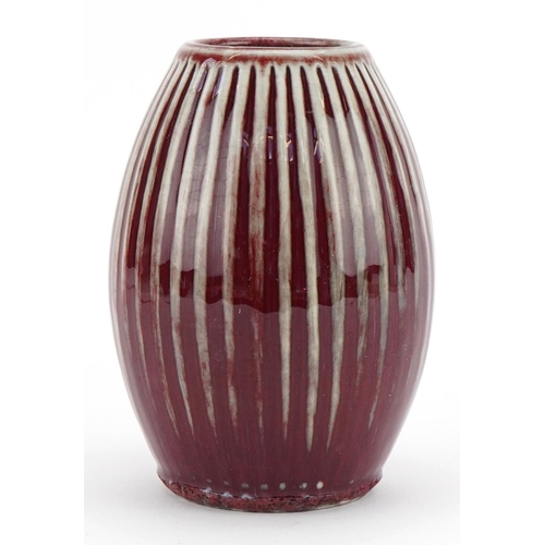 449 - Chinese porcelain fluted vase having a sang de boeuf glaze, 15cm high