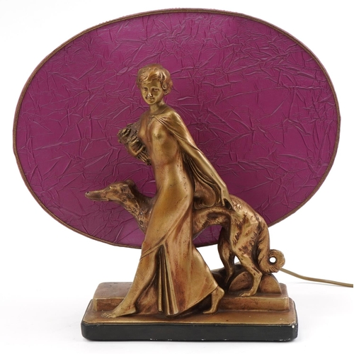 487 - Art Deco gilt plaster figural table lamp with shade in the form of a female with dog, 42cm wide