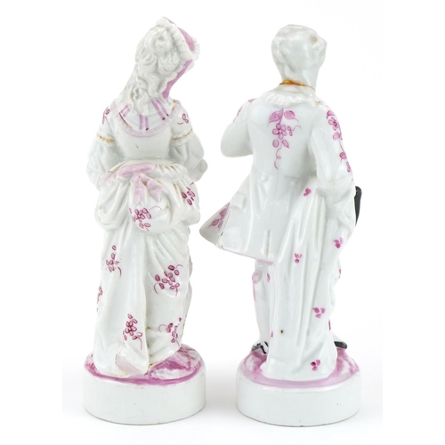 765 - Pair of 19th century continental porcelain figures hand painted in pink with flowers, the largest 18... 