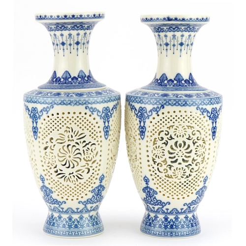 709 - Pair of Chinese blue and white porcelain reticulated two piece flower vases decorated with flowers a... 