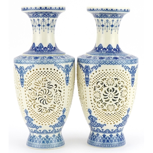 709 - Pair of Chinese blue and white porcelain reticulated two piece flower vases decorated with flowers a... 