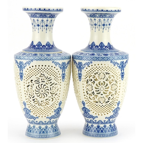 709 - Pair of Chinese blue and white porcelain reticulated two piece flower vases decorated with flowers a... 