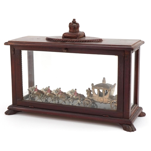 636 - Commemorative interest painted metal coronation coach housed in a mahogany glazed display case with ... 