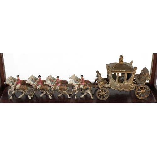 636 - Commemorative interest painted metal coronation coach housed in a mahogany glazed display case with ... 