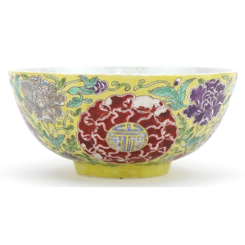 621 - Chinese yellow ground porcelain bowl hand painted in the famille rose palette with flowers amongst f... 