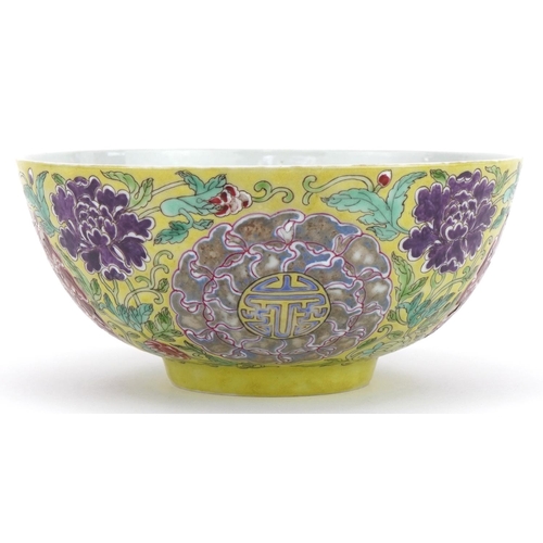 621 - Chinese yellow ground porcelain bowl hand painted in the famille rose palette with flowers amongst f... 