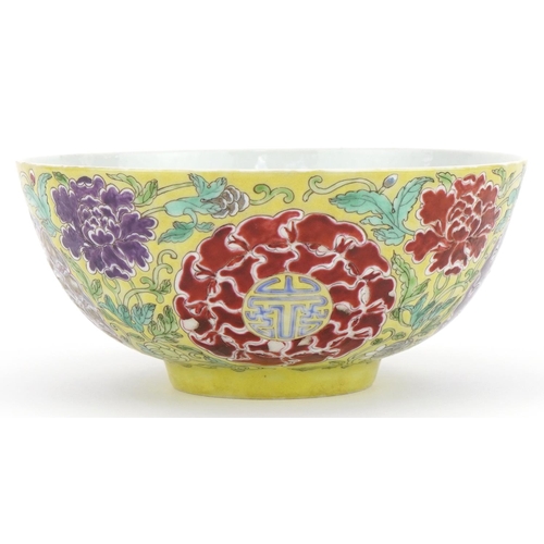 621 - Chinese yellow ground porcelain bowl hand painted in the famille rose palette with flowers amongst f... 