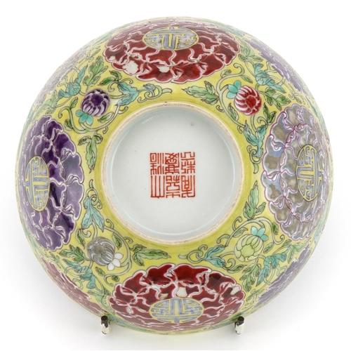 621 - Chinese yellow ground porcelain bowl hand painted in the famille rose palette with flowers amongst f... 