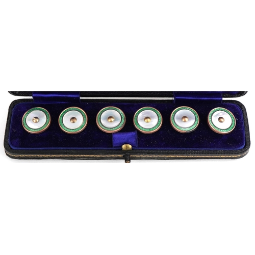 387 - Set of six 9ct gold mounted mother of pearl and green enamel studs housed in a fitted silk and velve... 