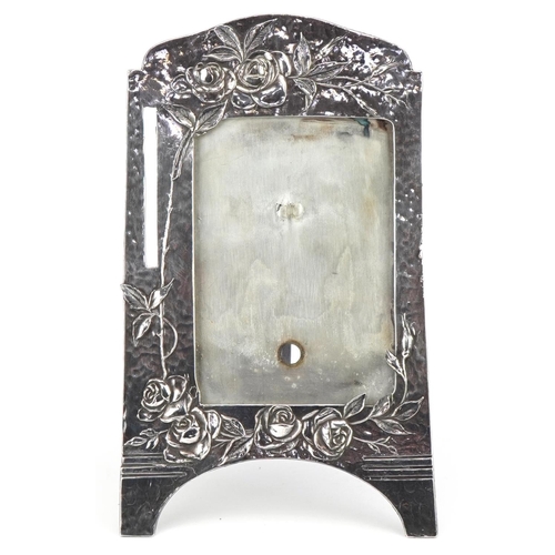 121 - Manner of WMF, Art Nouveau pewter easel photo frame cast in relief with stylised roses, 25cm high