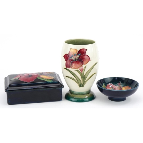 179 - Moorcroft pottery hand painted with flowers including a William Moorcroft box and cover, vase and bo... 