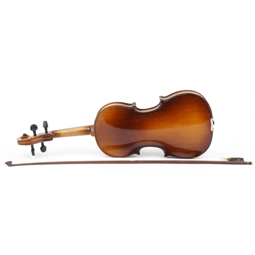 653 - Old wooden violin with bow having mother of pearl frog and case, the violin back 14.25 inches in len... 