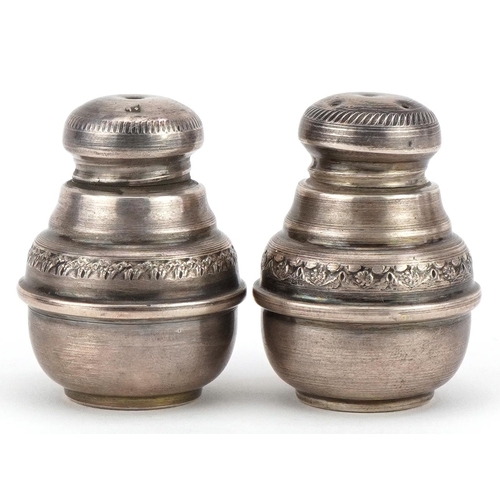 289 - Pair of Islamic silver casters with engraved decoration, indistinct impressed marks, 4.5cm high, 29.... 