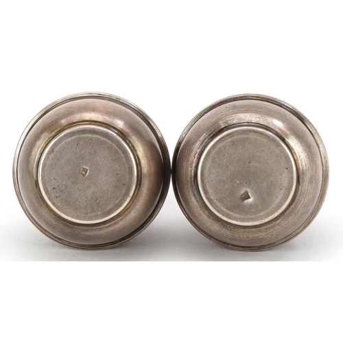 289 - Pair of Islamic silver casters with engraved decoration, indistinct impressed marks, 4.5cm high, 29.... 