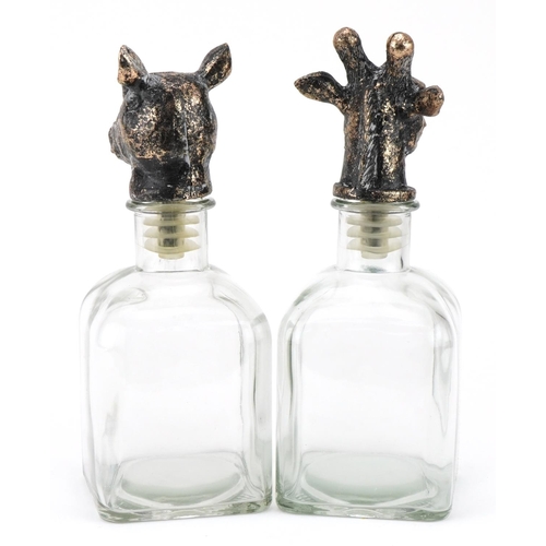 705 - Pair of novelty glass decanters with rhinoceros and giraffe head stoppers, the largest 24cm high