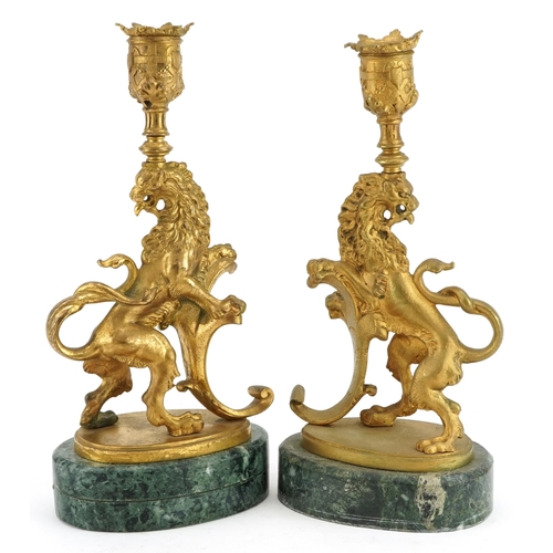 172 - Pair of Italian style gilt metal candlesticks in the form of rampant lions raised ooval green marble... 