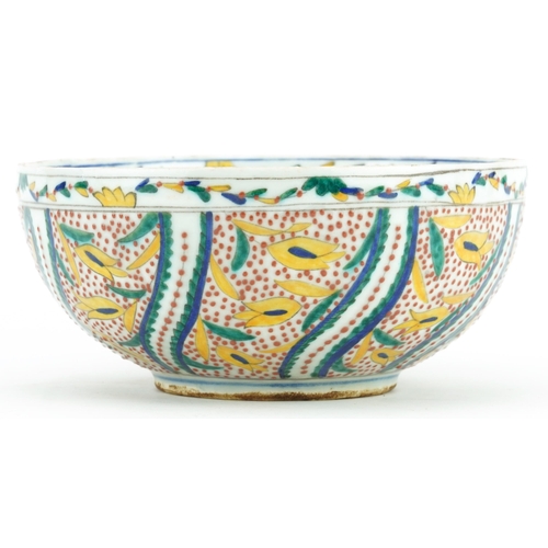 67 - Turkish Ottoman Kutahya pottery bowl hand painted with stylised flowers, 19.5cm in diameter