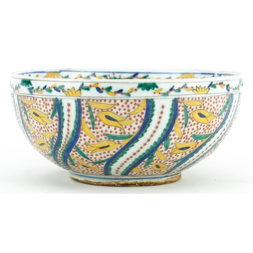 67 - Turkish Ottoman Kutahya pottery bowl hand painted with stylised flowers, 19.5cm in diameter