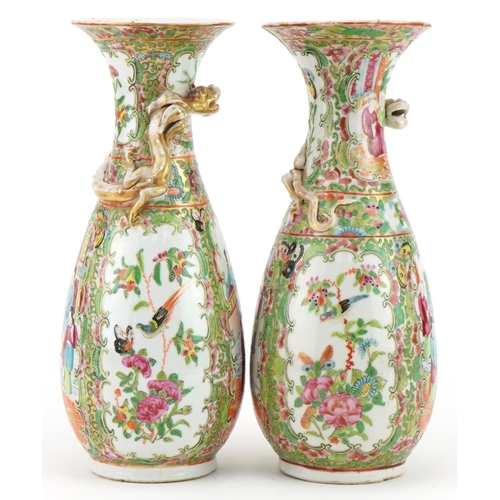 153 - Pair of Chinese Canton porcelain vases, each decorated in relief with a dragon, each hand painted in... 