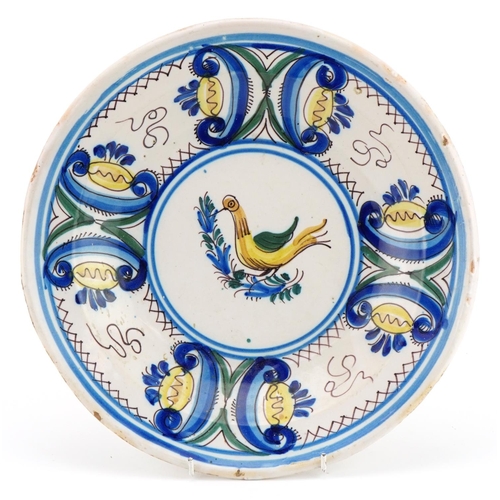 139 - 18th/19th century European tin glazed Maiolica shallow bowl hand painted with a bird and flowers, in... 