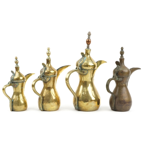 74 - Four Omani brass dallah coffee pots, the largest 38cm high