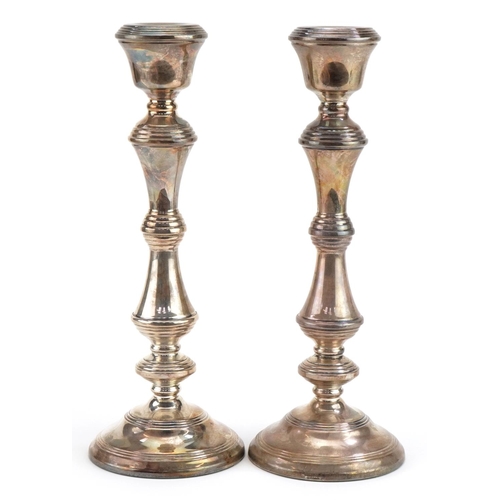 145 - W I Broadway & Co, large pair of Elizabeth II silver filled candlesticks, one with British Petroleum... 