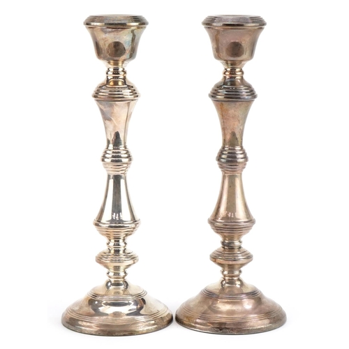 145 - W I Broadway & Co, large pair of Elizabeth II silver filled candlesticks, one with British Petroleum... 