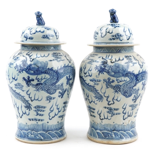 103 - Large pair of Chinese blue and white porcelain baluster vases and covers hand painted with dragons c... 