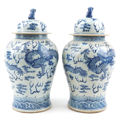 103 - Large pair of Chinese blue and white porcelain baluster vases and covers hand painted with dragons c... 