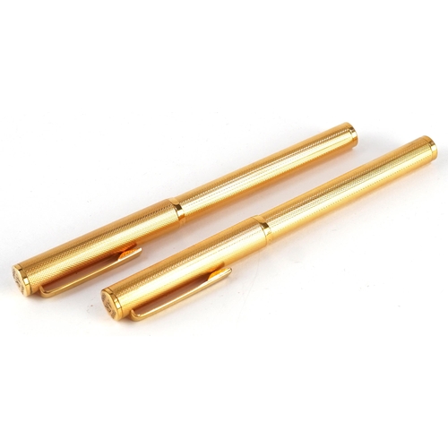 133 - Two Dunhill gold plated fountain pens with 14ct gold nibs