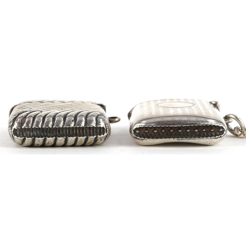 256 - Two Edwardian and later silver vestas, one with embossed decoration and a silver Belcher link chain,... 