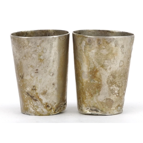 577 - Pair of German Art Nouveau 800 grade silver spirit cups embossed with stylised flowers, 4.5cm high, ... 