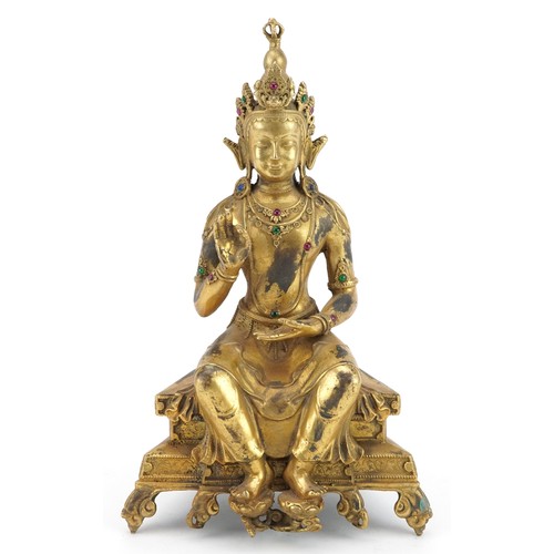 105 - Chino Tibetan jewelled gilt bronze figure of seated Buddha, 24cm high