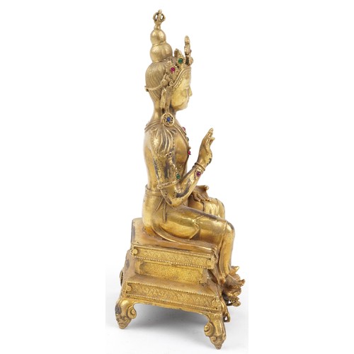 105 - Chino Tibetan jewelled gilt bronze figure of seated Buddha, 24cm high